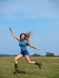 happy woman running in a field