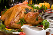 Garnished roasted turkey on holiday decorated table