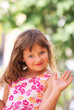 A girl with long hair, blue eyes, in the summer .