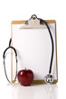 A doctor or nurses clipboard with a stethoscope and a red apple