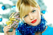 Beautiful young woman next to christmas tree