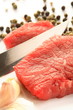 Meat, knife, pepper and garlic