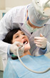 Vertical image of female patient with dentist over her