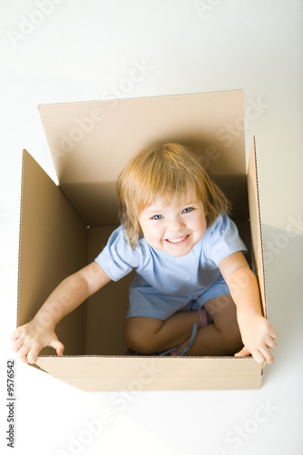 Photo: Happy young girl in box Happy young girl in box