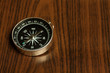 magnetic compass with wooden background