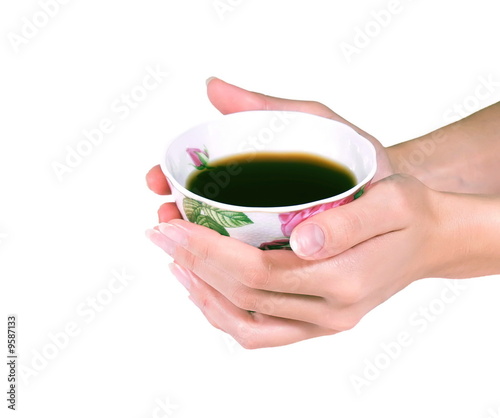 Photo: Female hands hold a coffee or tea cup Female hands hold a coffee or tea cup