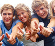 Young teenagers showing thumbs up sign