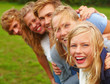 Foto: Closeup portrait of happy young teens in a line Closeup portrait of happy young teens in a line