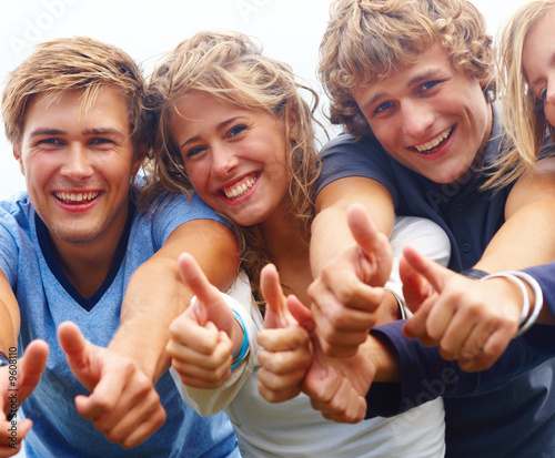 Photo: Young teenagers showing thumbs up sign Young teenagers showing thumbs up sign