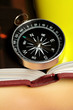 Magnetic compass on a colorufl book