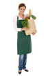 Woman in apron holding grocery bag