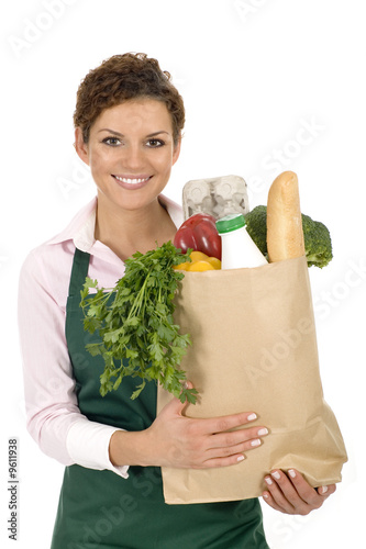 Photo: Shop Assistant Holding Grocery Bag Shop Assistant Holding Grocery Bag