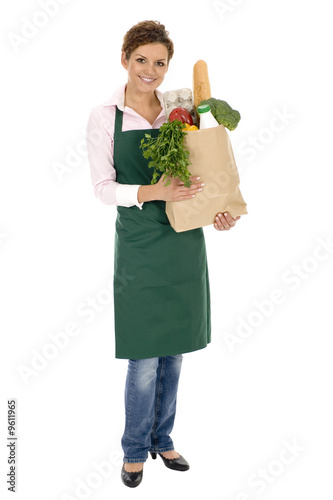 Photo: Woman in apron holding grocery bag Woman in apron holding grocery bag