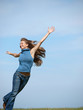 woman with arms raised running