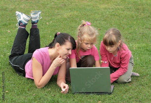 Photo: young woman and two girls with laptop young woman and two girls with laptop