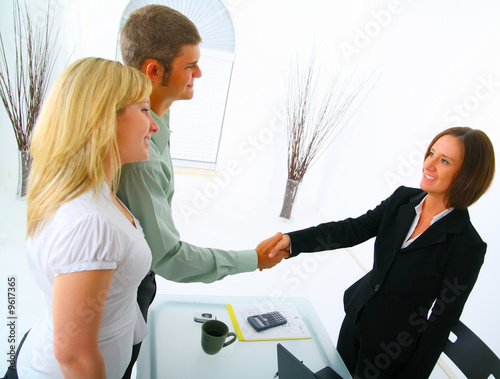 professional caucasian couple with broker in purchasing a house