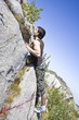Young and strong boy climbing a mountain