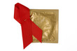 Red Ribbon with gold condom wrapper on a white background