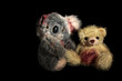 koala and yellow bear  on a black background