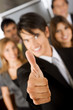 business man with his thumb up - business team behind.