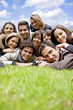 happy group of friends smiling outdoors in a park
