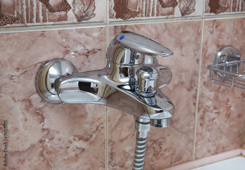 The tap of a shower in a bathroom