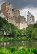 A pond in central park with buildings behind it in New York City