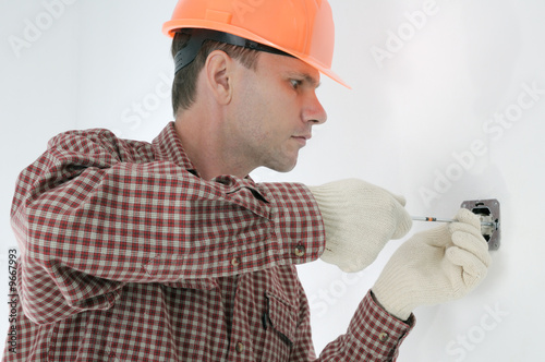 man installing electrical box