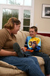 mother and son on couch lauging together mother and son on couch lauging together