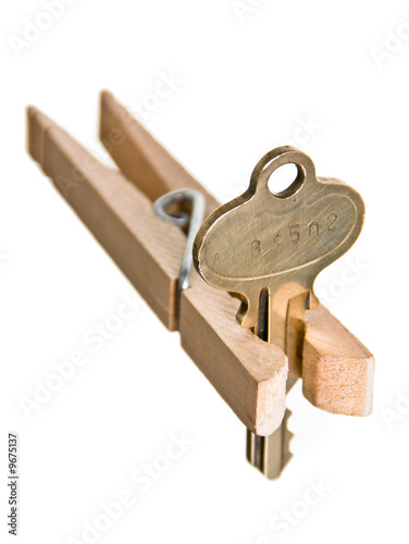 Photo: Mortgage Crises Concept: House Key Pinched by Clothespin Mortgage Crises Concept: House Key Pinched by Clothespin