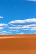 An image of bright blue sky beyond golden sand dunes An image of bright blue sky beyond golden sand dunes