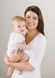 Foto: Studio shot of loving mother holding baby Studio shot of loving mother holding baby