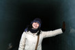 Asian woman having fun inside an ice tunnel during winter.