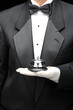 Butlers holding call bell in gloved hand in front of body Butlers holding call bell in gloved hand in front of body