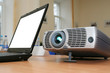 Foto: Laptop with computer projector on table Laptop with computer projector on table