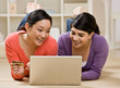Friends using credit card to purchase goods on the internet
