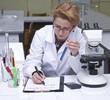 Female researcher taking notices at her workplace