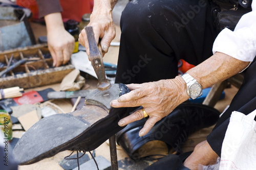 Photo: Shoe repair on street in Chinatown in Manhattan Shoe repair on street in Chinatown in Manhattan