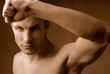 man does sports exercises having lifted above  head  hand