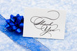 Thank you card with ribbon and bow on blue snowflake