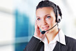 Woman wearing headset in office; could be receptionist Woman wearing headset in office; could be receptionist