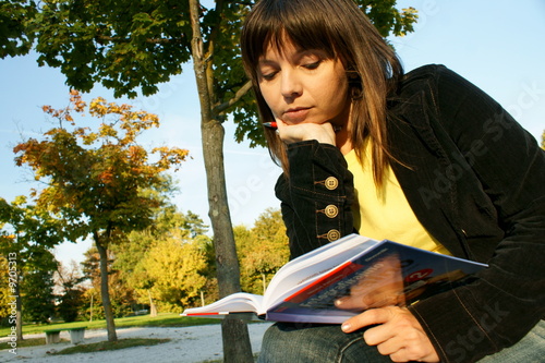 Photo: Cute girl reading a book Cute girl reading a book