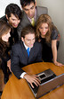 business team browsing on a laptop in their office
