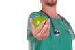 Doctor with a green apple on his hand