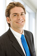 Friendly business man portrait - smiling in his office.