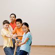 Determined children pulling on rope in tug-of-war