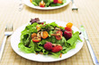 Healthy green salad with berries and cherry tomatoes
