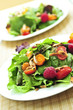 Healthy green salad with berries and cherry tomatoes