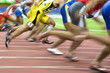 100 meters athletes in action with intentional blurring.