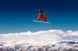Snowboarder in the air with deep blue sky in background